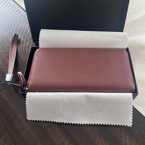 ew! In the box brown leather wristlet/wallet. Wristlet piece can be removed.